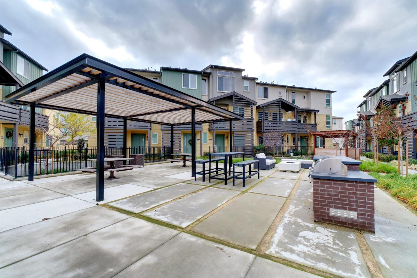 1888 Joshua Tree Circle Milpitas, CA 95035 - Photo 44 of 50 a view of a patio with a table and chairs under an umbrella