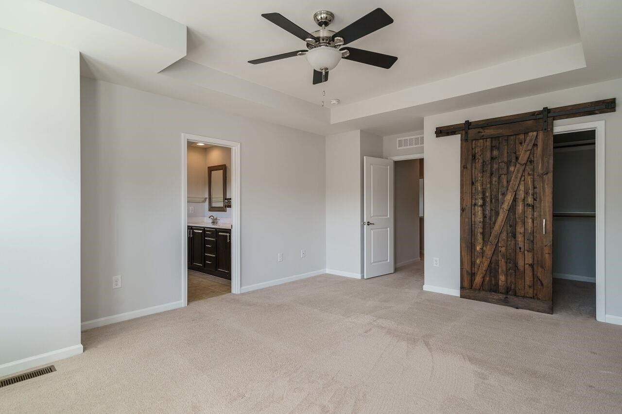 1340 Rodessa Run Raleigh, NC 27607 - Photo 17 of 29 Working barn door on sliders to reveal the walk in closet with wooden shelving! Owner's Suite