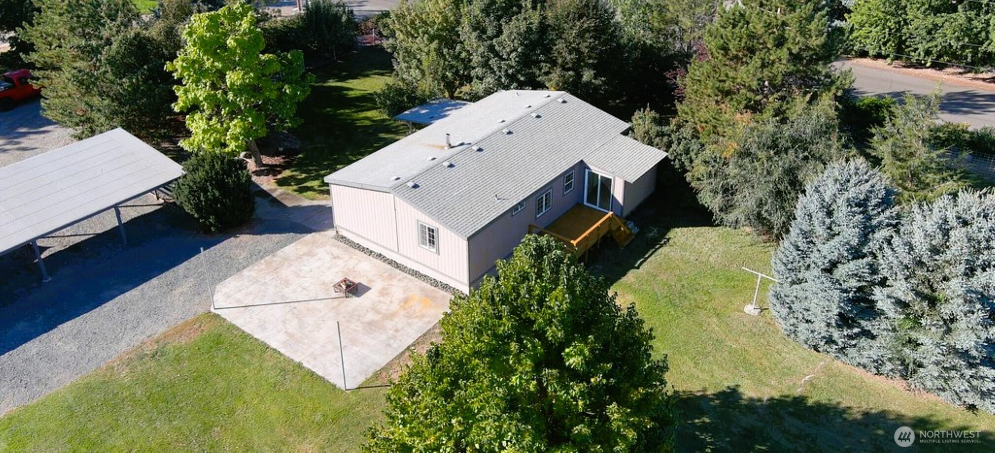 6883 Ferguson Road Northeast Moses Lake, WA 98837 - Photo 1 of 39 an aerial view of a house with swimming pool and large trees