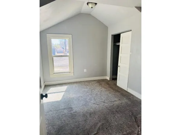 a view of an empty room with a window