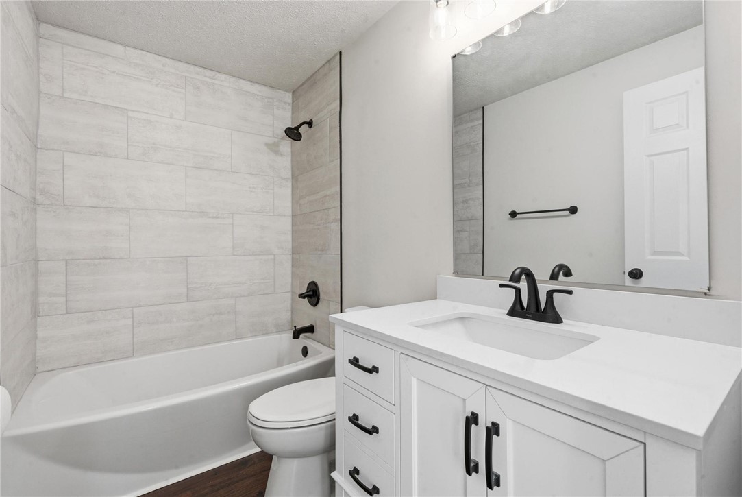 1353 Foust Road Xenia, OH 45385 - Photo 40 of 50 This newly renovated bathroom features a modern vanity and a sleek, tiled shower and bathtub combination.