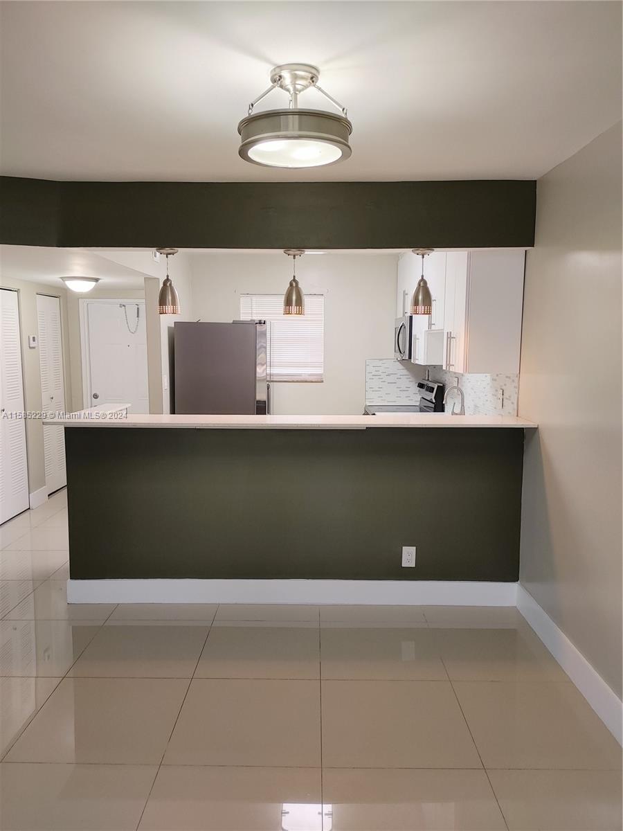 8330 Sands Point Boulevard, Unit N107 Tamarac, FL 33321 - Photo 1 of 13 a view of cabinets