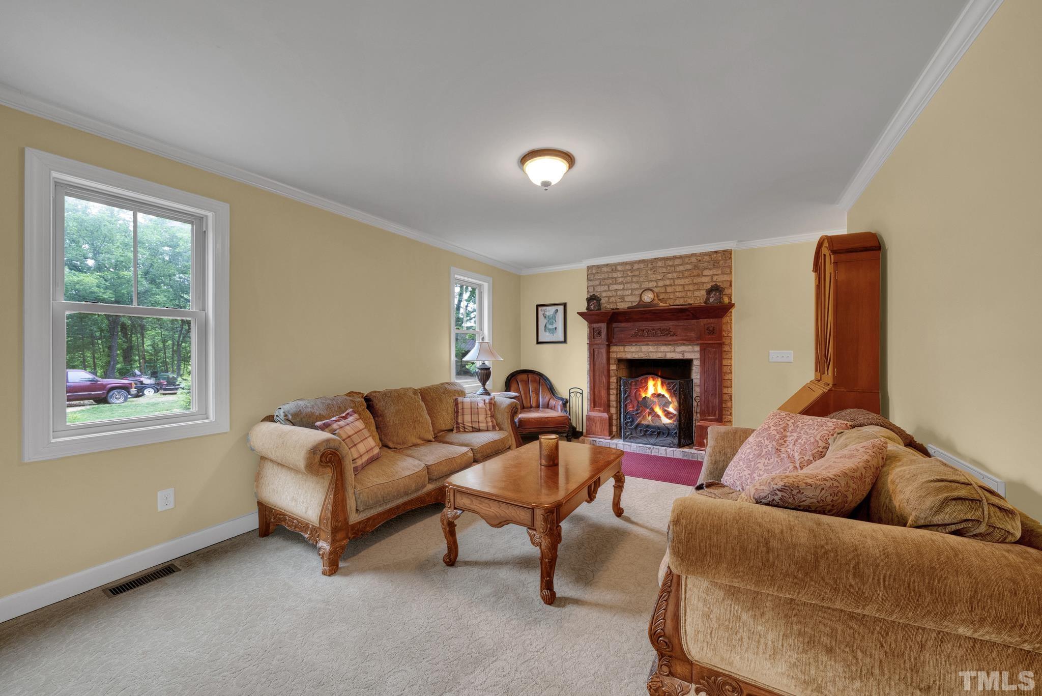 1118 Mountain Road Roxboro, NC 27574 - Photo 11 of 24 a living room with furniture and a fireplace