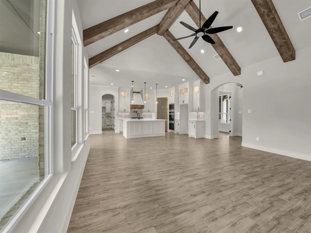 313 Wrangler Court Weatherford, TX 76088 - Photo 12 of 40 a view of a living room a hallway with wooden floor and chandelier