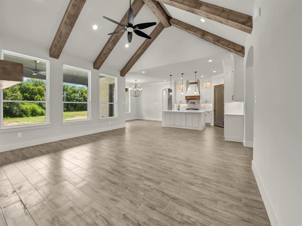 313 Wrangler Court Weatherford, TX 76088 - Photo 13 of 40 a view of an empty room with a window and wooden floor