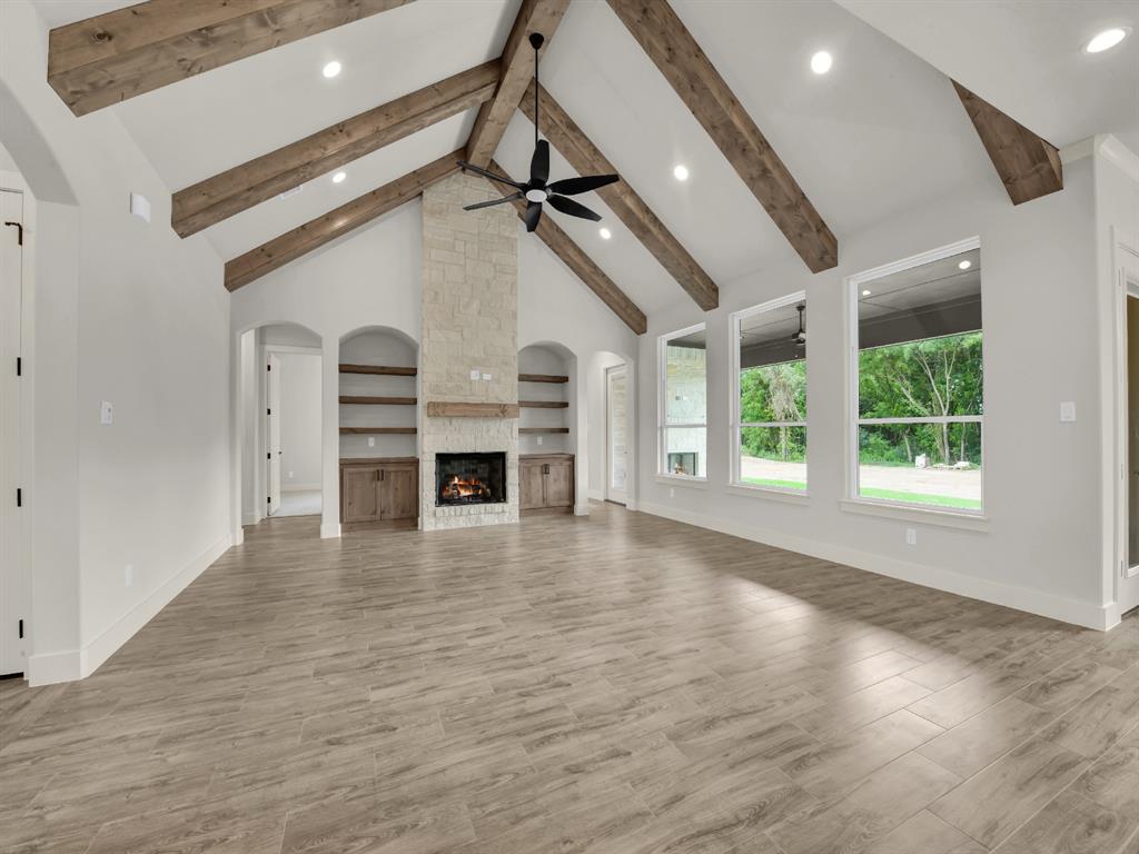 313 Wrangler Court Weatherford, TX 76088 - Photo 14 of 40 a view of empty room with wooden floor and fan