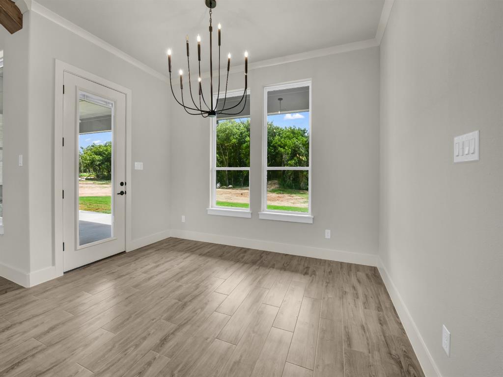 313 Wrangler Court Weatherford, TX 76088 - Photo 23 of 40 a view of empty room with wooden floor and fan