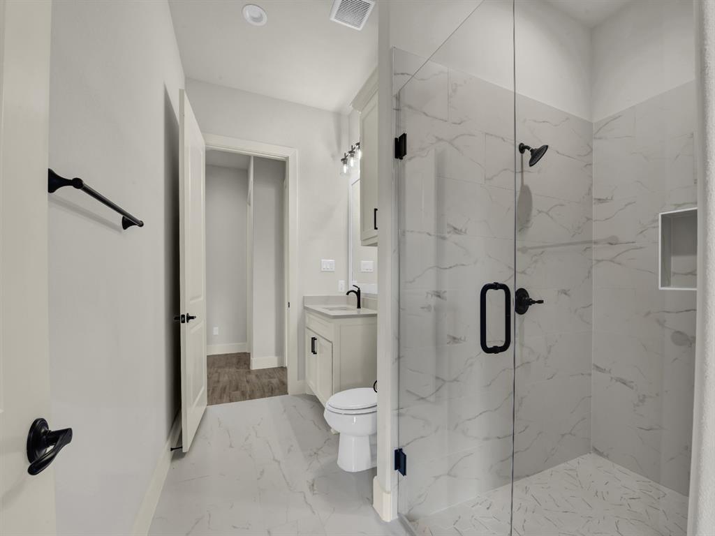 313 Wrangler Court Weatherford, TX 76088 - Photo 37 of 40 a bathroom with a shower and a toilet