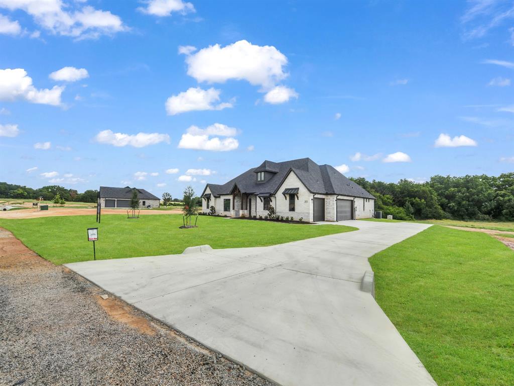 313 Wrangler Court Weatherford, TX 76088 - Photo 8 of 40 a view of a house with a big yard