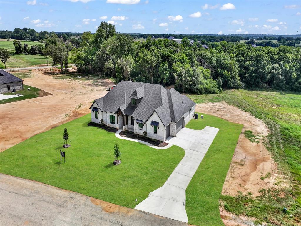 313 Wrangler Court Weatherford, TX 76088 - Photo 9 of 40 an aerial view of a house with a yard and a garden