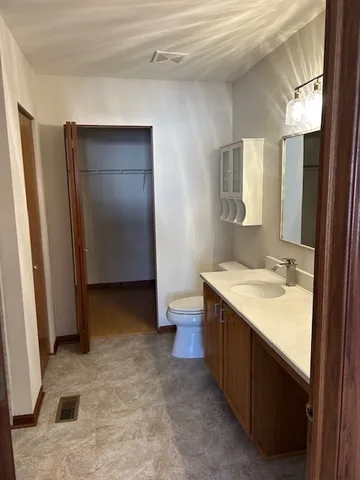 a bathroom with a sink toilet double vanity and tub