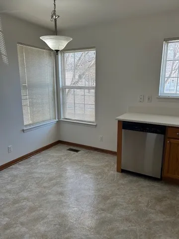 an empty room with chandelier fan