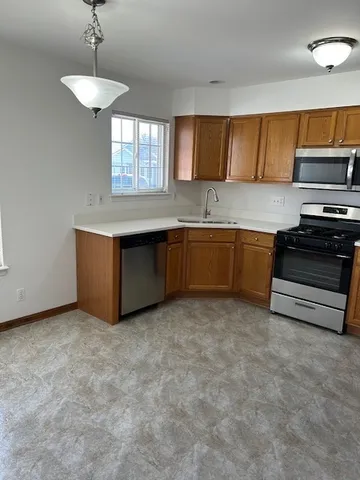 a kitchen with stainless steel appliances granite countertop a stove and a sink