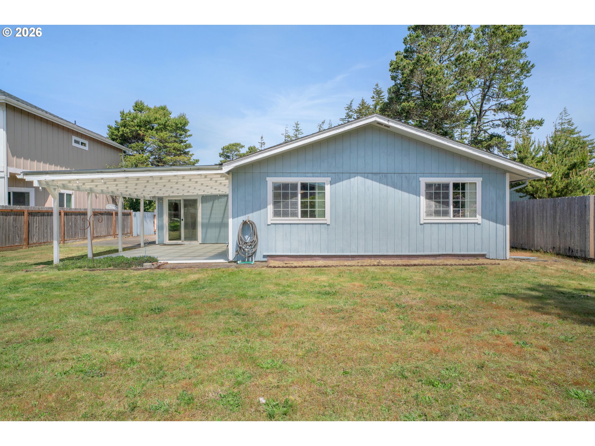 1142 9th Street Florence, OR 97439 - Photo 33 of 41 a house view with a garden space