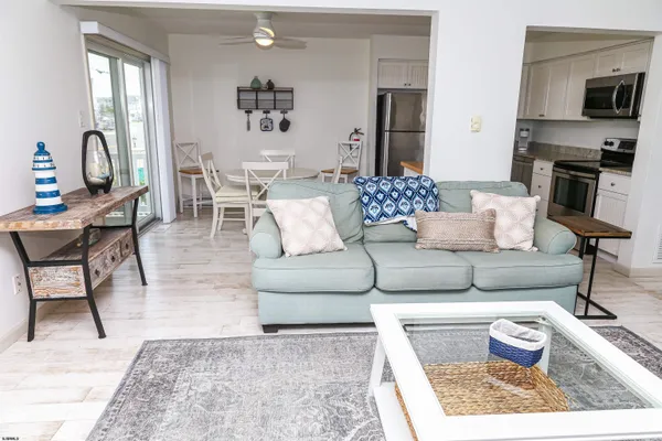 a living room with furniture wooden floor and a rug