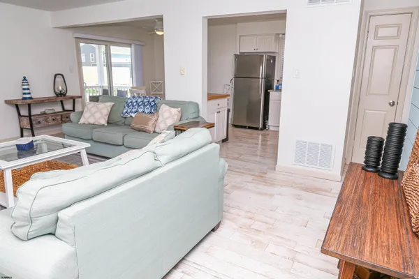 a living room with furniture a flat screen tv and a large window