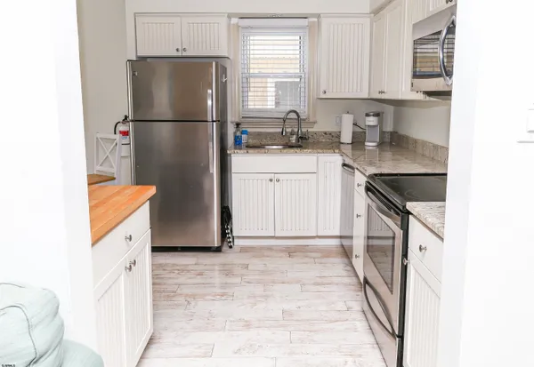 a kitchen with a refrigerator stove and microwave