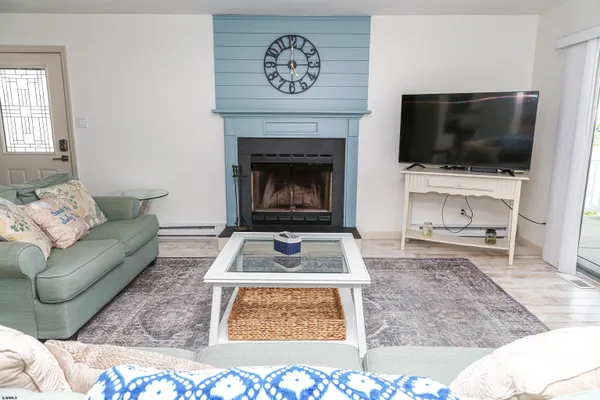 a living room with furniture a rug and a flat screen tv