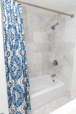 a bathroom with a bathtub and shower