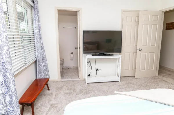 a bathroom with a granite countertop sink and a toilet