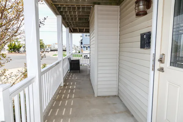 a view of a porch with furniture and a yard