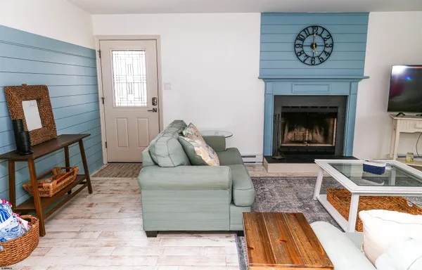 a living room with furniture and a fireplace