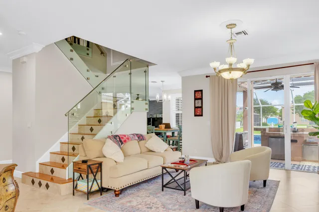 a kitchen with a dining table chairs stainless steel appliances and cabinets