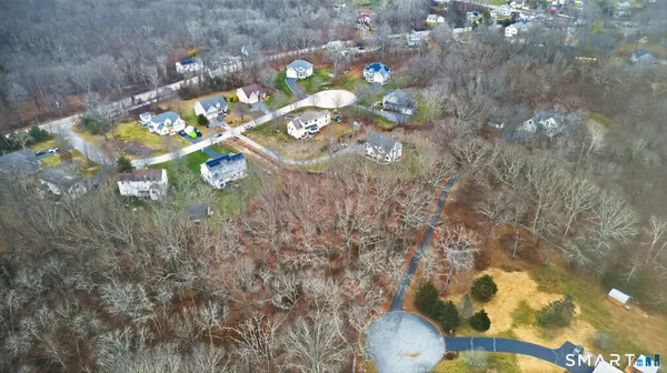 an aerial view of a house with a yard and lake view