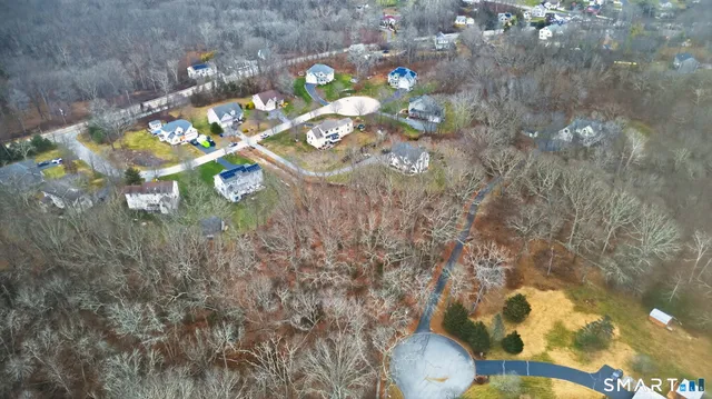 an aerial view of a house with a yard and lake view