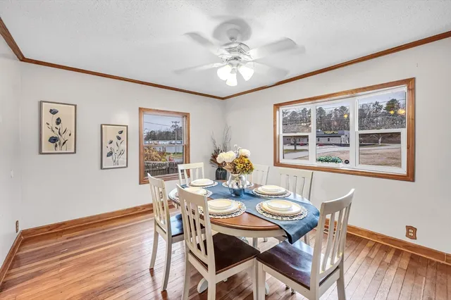 a view of a dining room with furniture window and wooden floor
