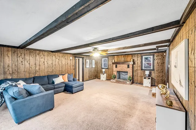 a living room with furniture and large windows