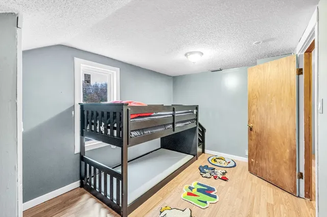 a bedroom with bunk bed and a window