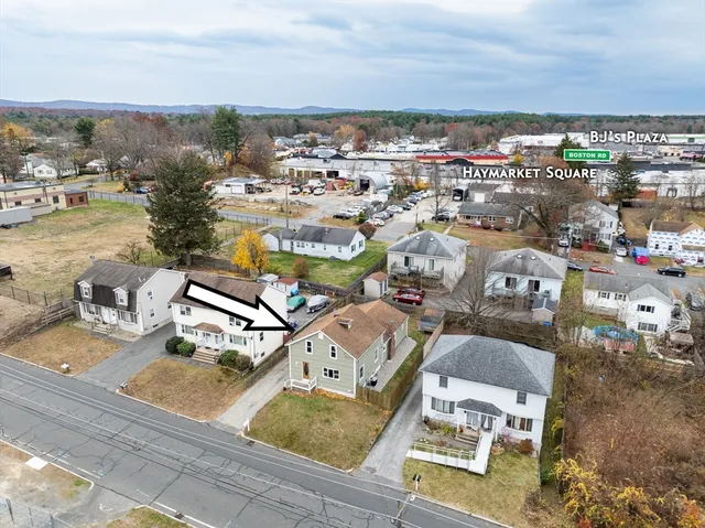 an aerial view of residential houses with outdoor space