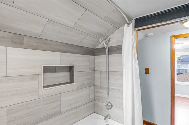 a bathroom with a shower and a sink