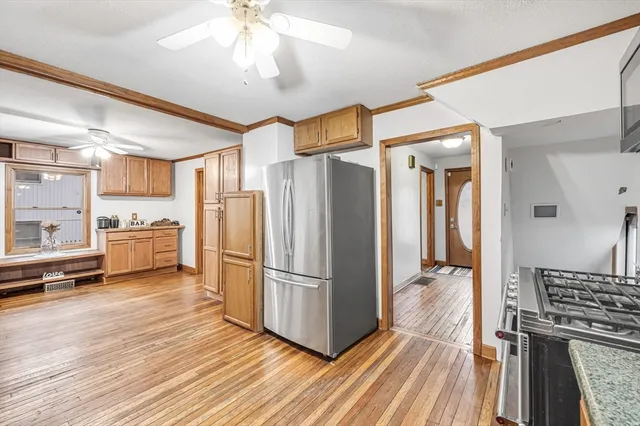 a kitchen with stainless steel appliances a refrigerator and a stove top oven