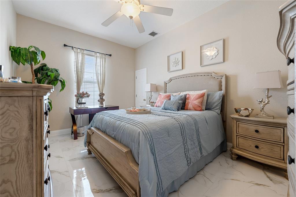 155 Hidden Woods Cove Altamonte Springs, FL 32701 - Photo 14 of 20 a bedroom with a bed and a chandelier