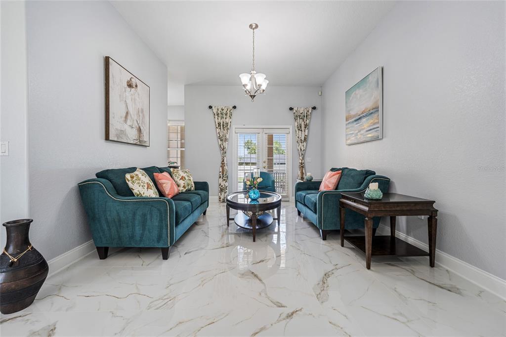 155 Hidden Woods Cove Altamonte Springs, FL 32701 - Photo 5 of 20 a living room with furniture and a chandelier