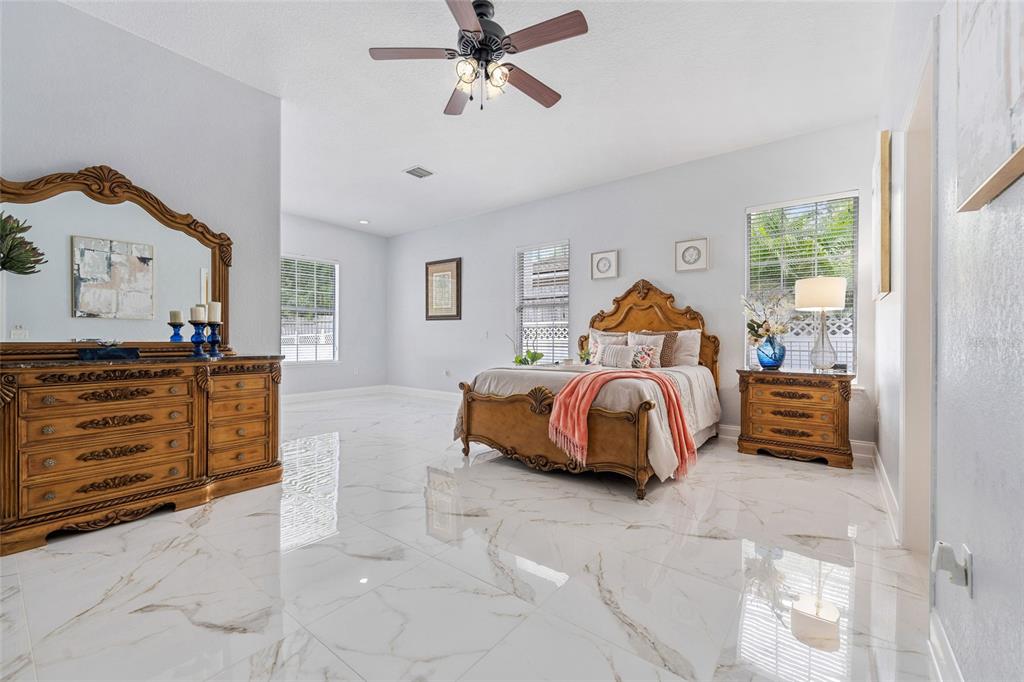 155 Hidden Woods Cove Altamonte Springs, FL 32701 - Photo 6 of 20 a bedroom with a bed and ceiling fan