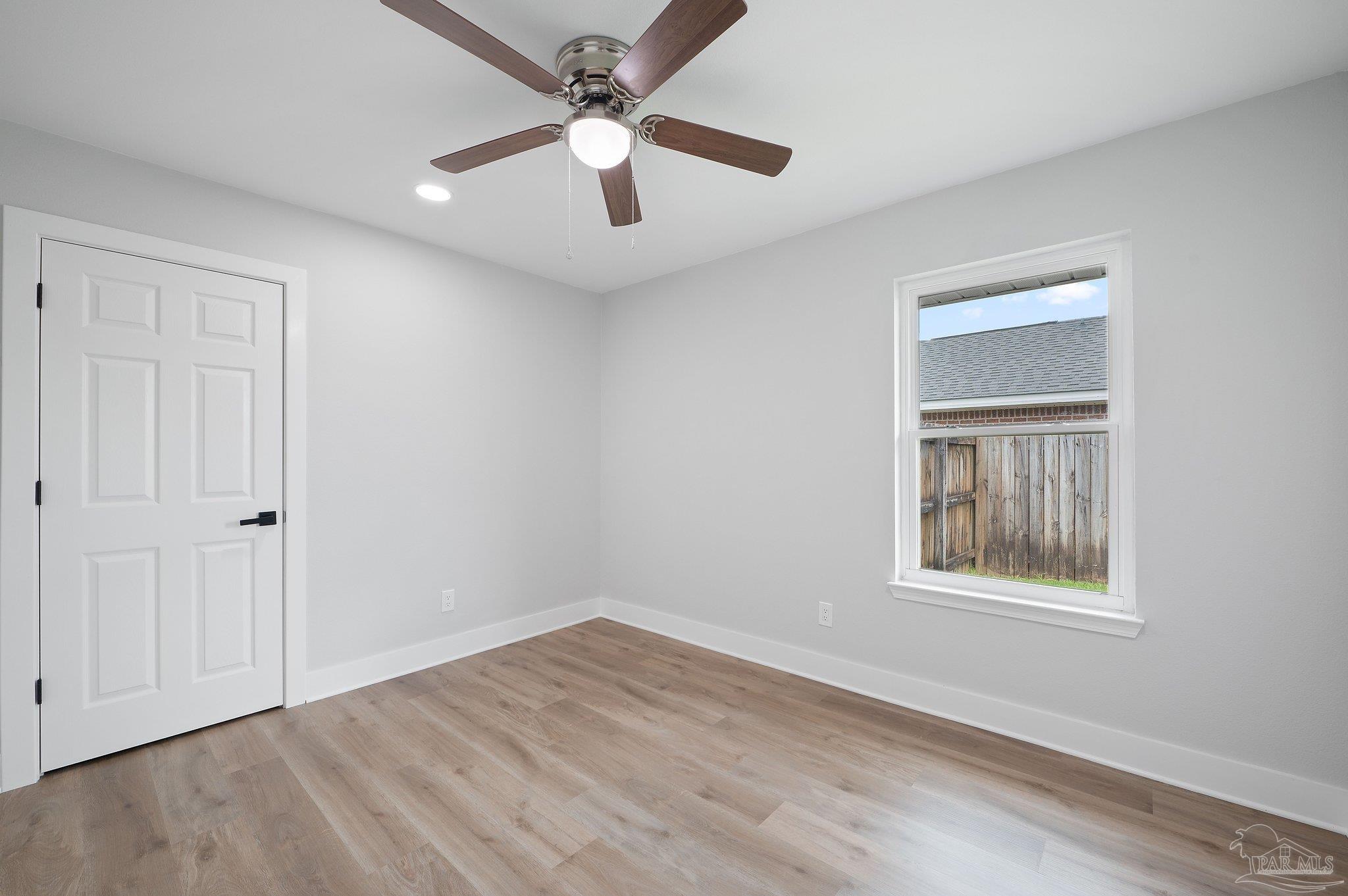 4290 Idell Lane Pace, FL 32571 - Photo 32 of 45 an empty room with a window and a ceiling fan