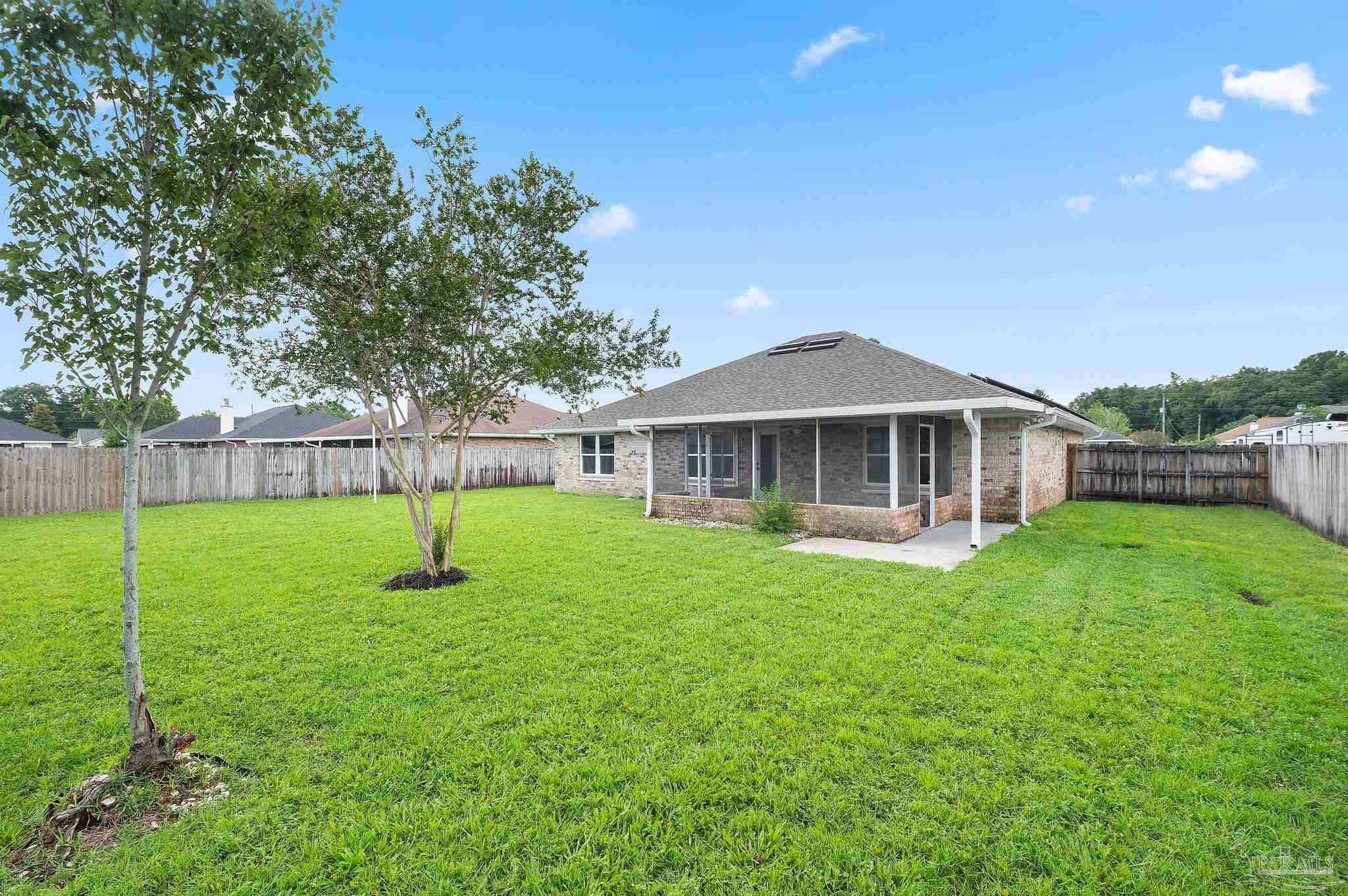 4290 Idell Lane Pace, FL 32571 - Photo 39 of 45 a front view of a house with a yard