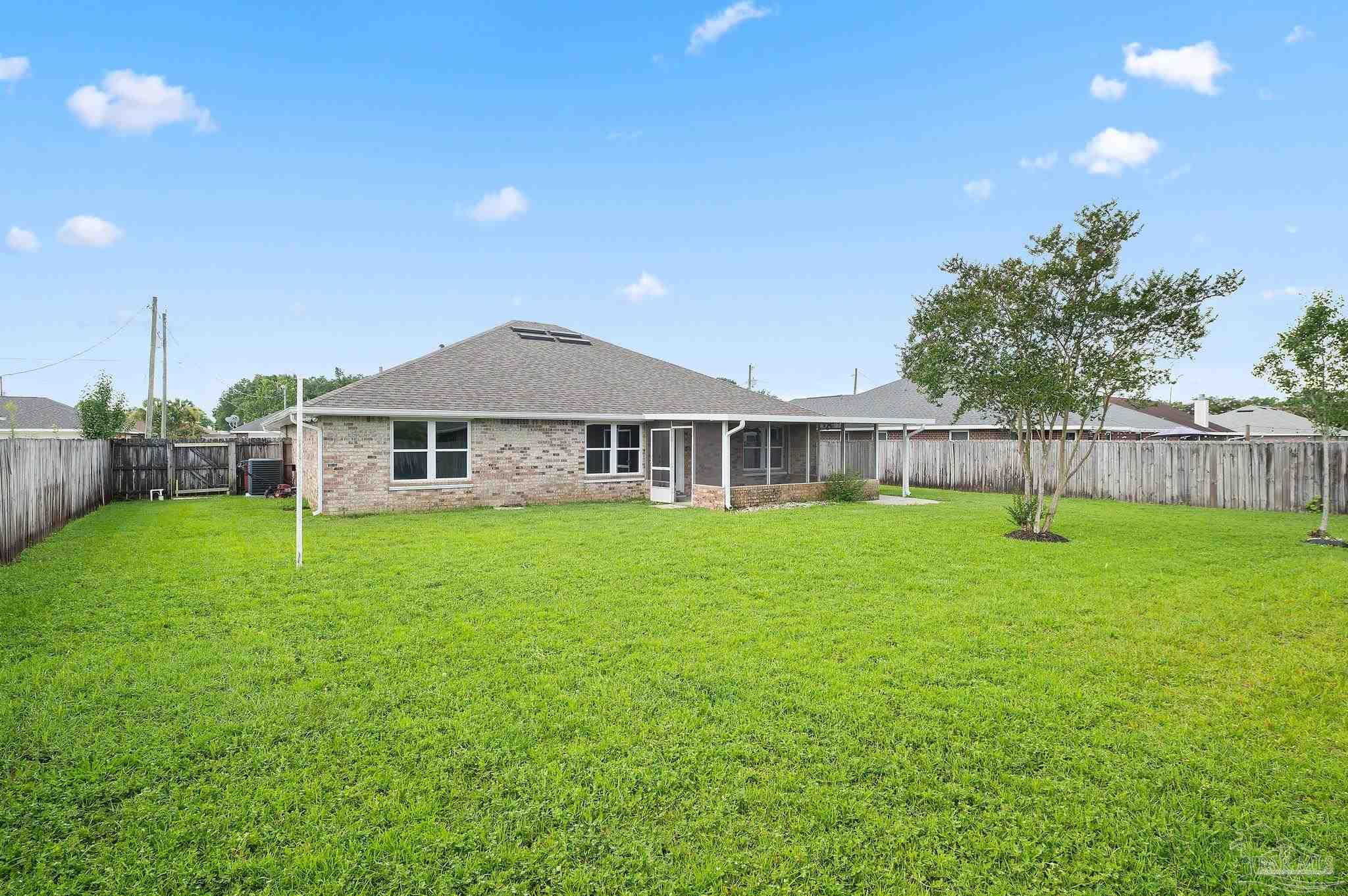 4290 Idell Lane Pace, FL 32571 - Photo 42 of 45 a view of a house with backyard and garden
