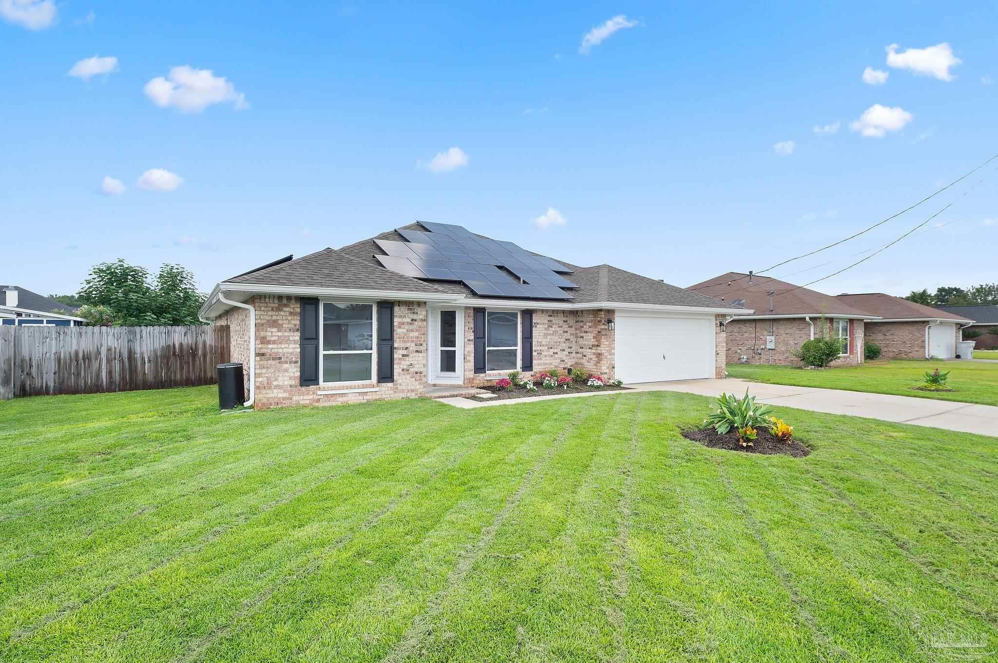 4290 Idell Lane Pace, FL 32571 - Photo 44 of 45 a front view of a house with a yard