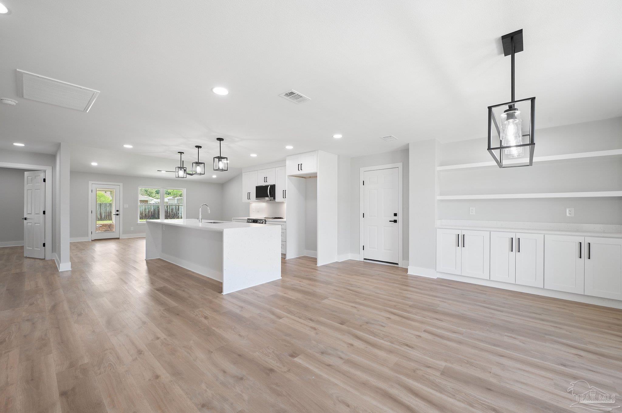 4290 Idell Lane Pace, FL 32571 - Photo 7 of 45 a view of kitchen with cabinets and wooden floor