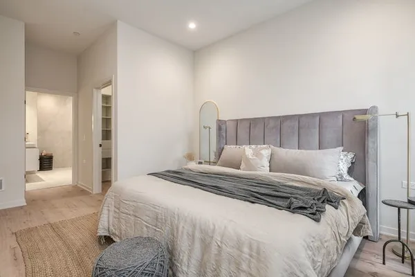 a bedroom with a bed and a mirror