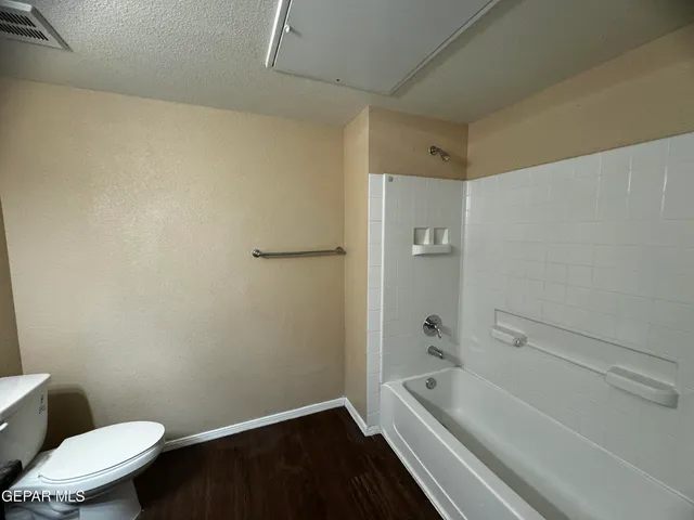 a bathroom with a granite countertop toilet a sink and bathtub