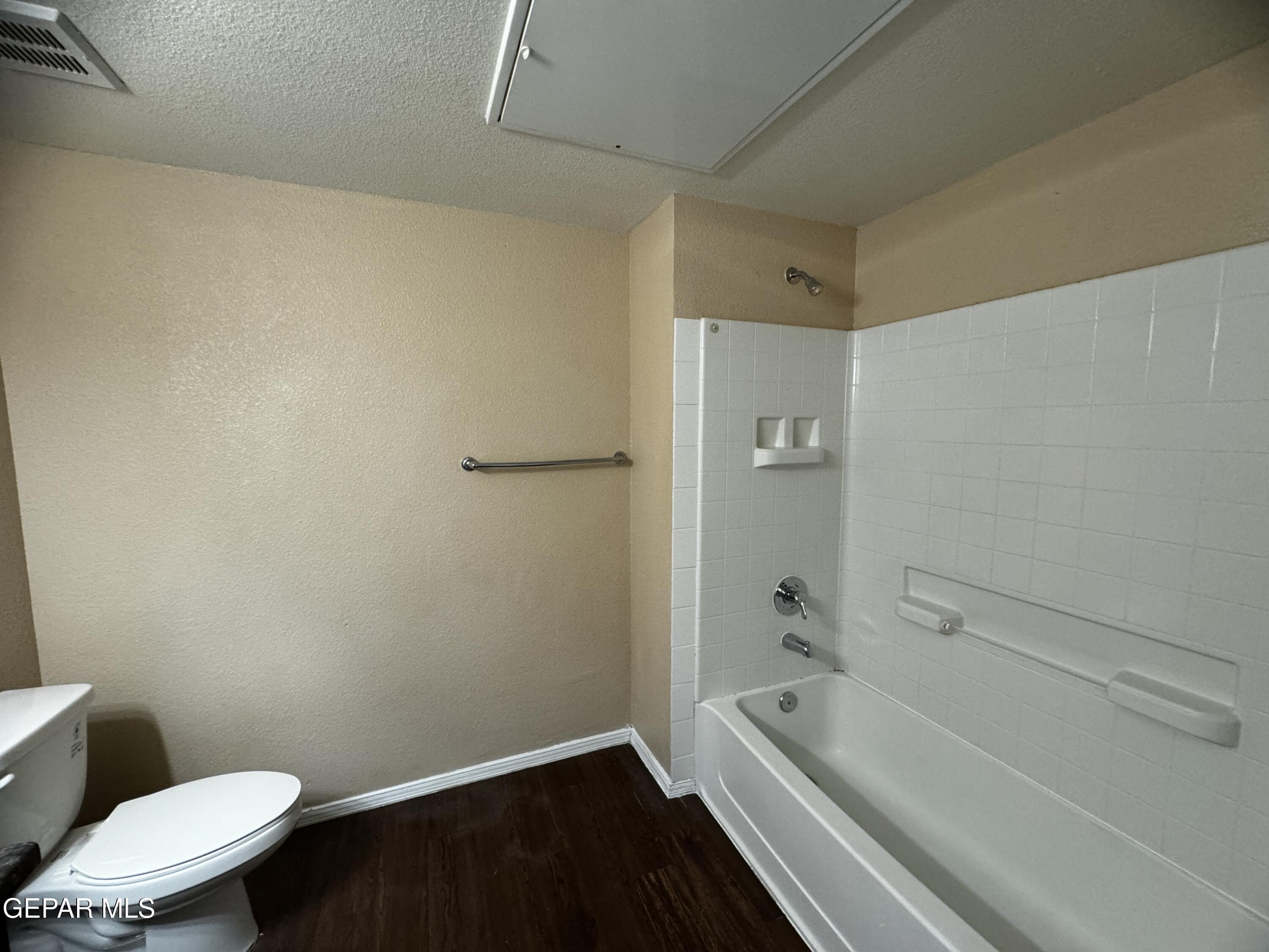 9811 Socorro Road, Unit 36 El Paso, TX 79927 - Photo 11 of 12 a bathroom with a granite countertop toilet a sink and bathtub
