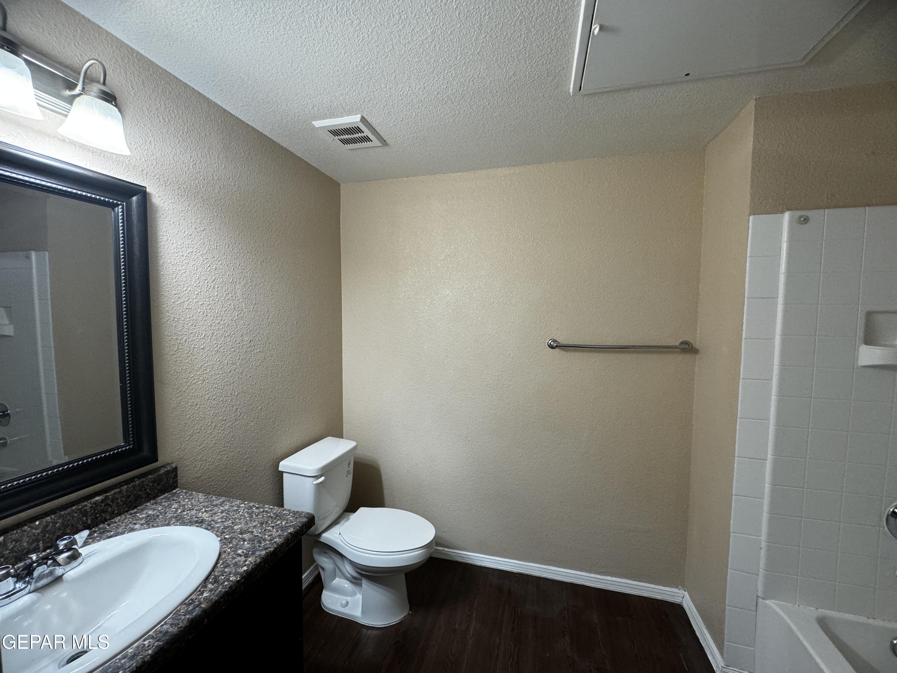 9811 Socorro Road, Unit 36 El Paso, TX 79927 - Photo 12 of 12 a bathroom with a granite countertop sink toilet and shower