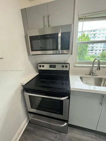 a kitchen with a stove and a microwave