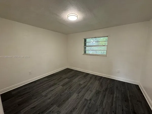 a view of room with wooden floor