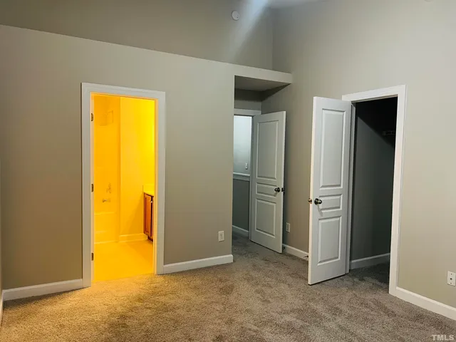 an empty room with closet and a window